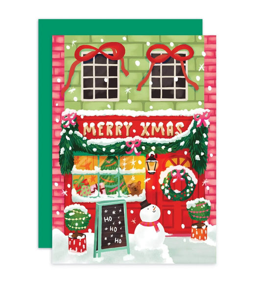 Aniet Illustration - Kerstkaart vrolijke kerst winkel merry Xmas met sneeuwpop - The Dreamer's Bookshop.